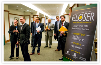 Student competitors in the hallway at Baylor Law, The Closer sign is visible on the right side of the image