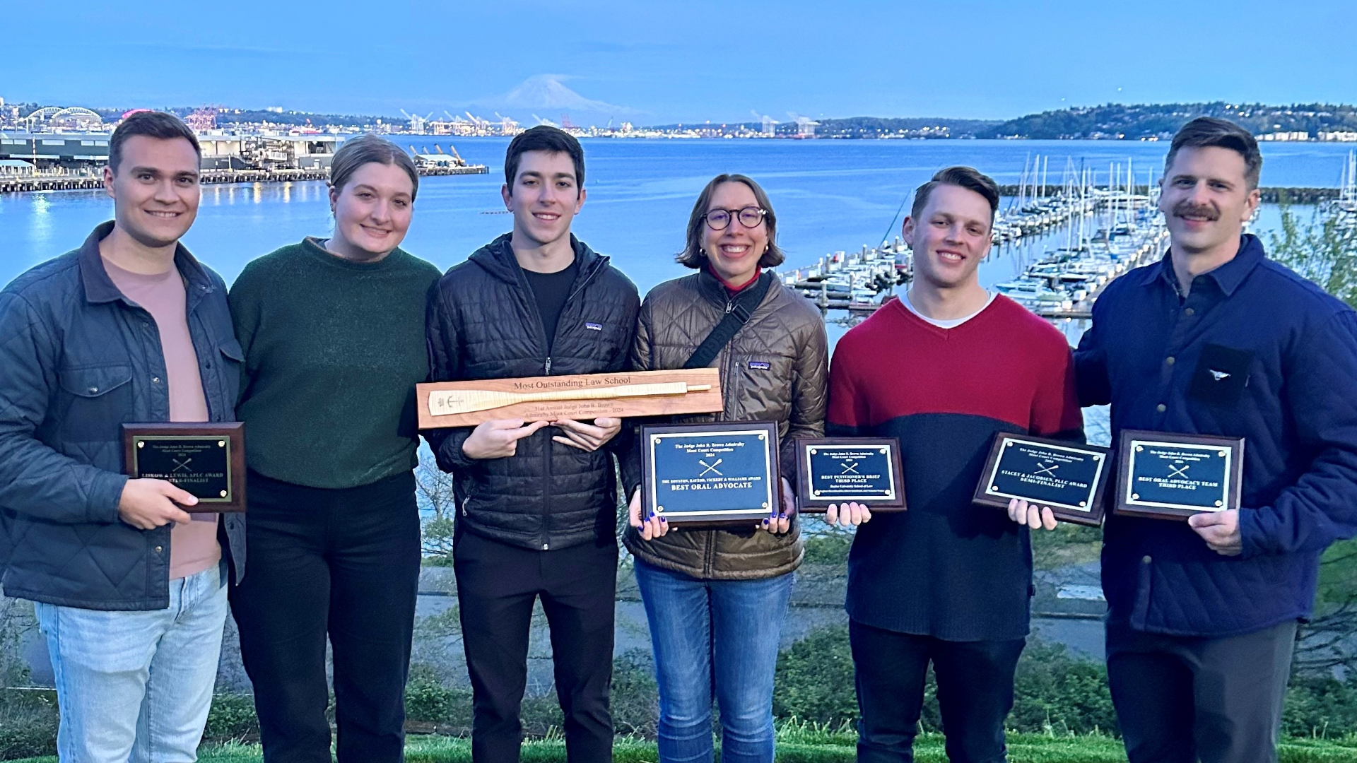 Baylor Law's moot court team poses in front of the harbor in Seattle after winning the 'Most Outstanding Law School’ award at the 2024 John R. Brown National Admiralty Law Moot Court Competition 
