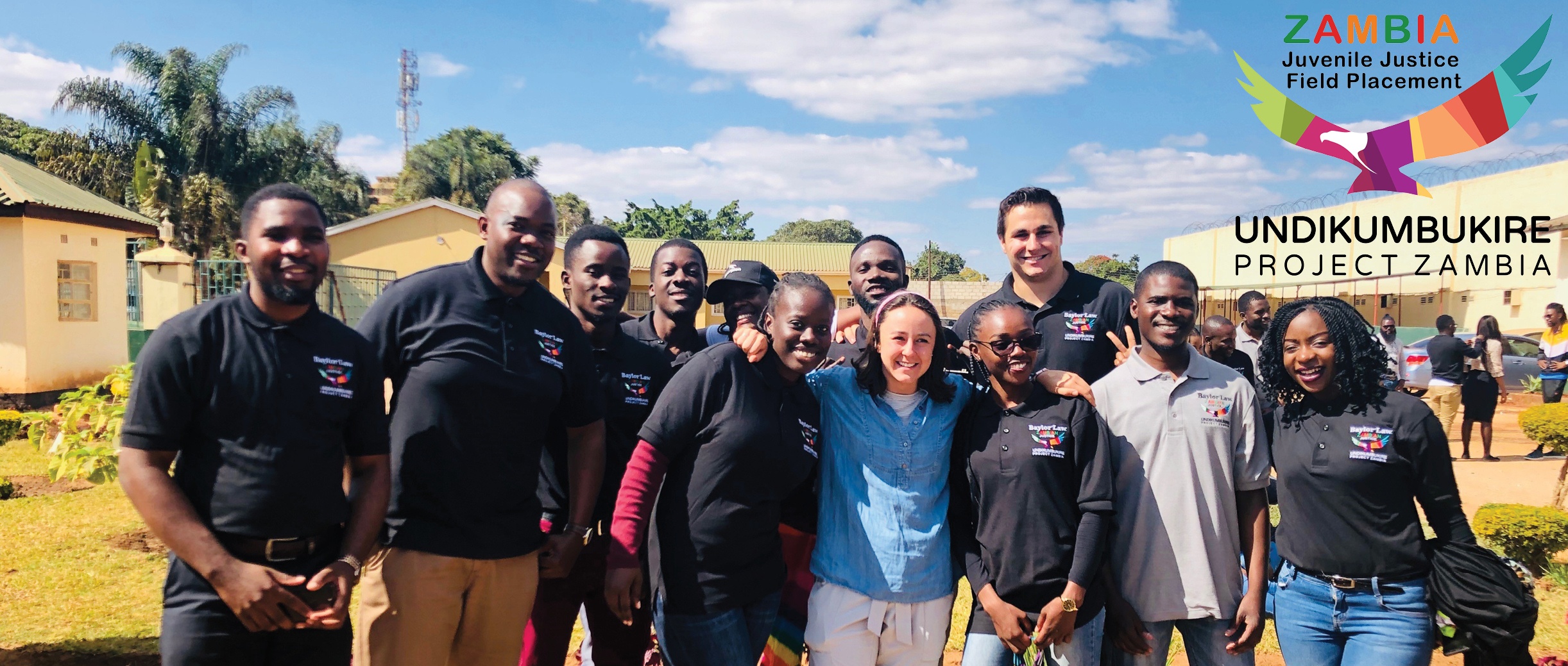 Baylor Law students pose with lawyers from UP Zambia in front of Lusaka Prison
