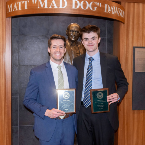 Keegan Coon and Matthew Zahn, Runners-up, pose in front of the Matt Dawson statue at Baylor Law