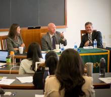 A panel of speakers in front of a classroom of students at the Business Law Bootcamp
