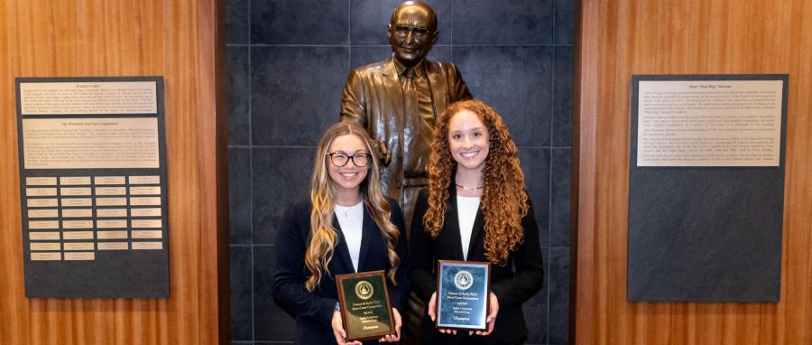 2023 Dawson & Sodd winners pose in front of Mad Dog Statue at Baylor Law
