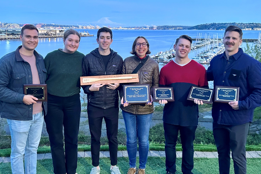 Baylor Law's moot court team poses in front of the harbor in Seattle after winning the 'Most Outstanding Law School’ award at the 2024 John R. Brown National Admiralty Law Moot Court Competition.
