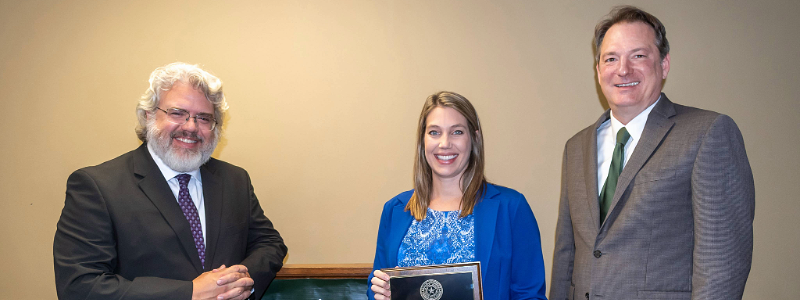 Tara Avants standing with McLennan County DA Josh Tetens and Baylor Law School's Dean Jeremy Counseller