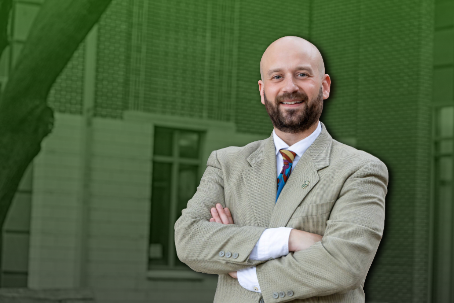 Professor Dyllan Taxman poses in front of Baylor Law School